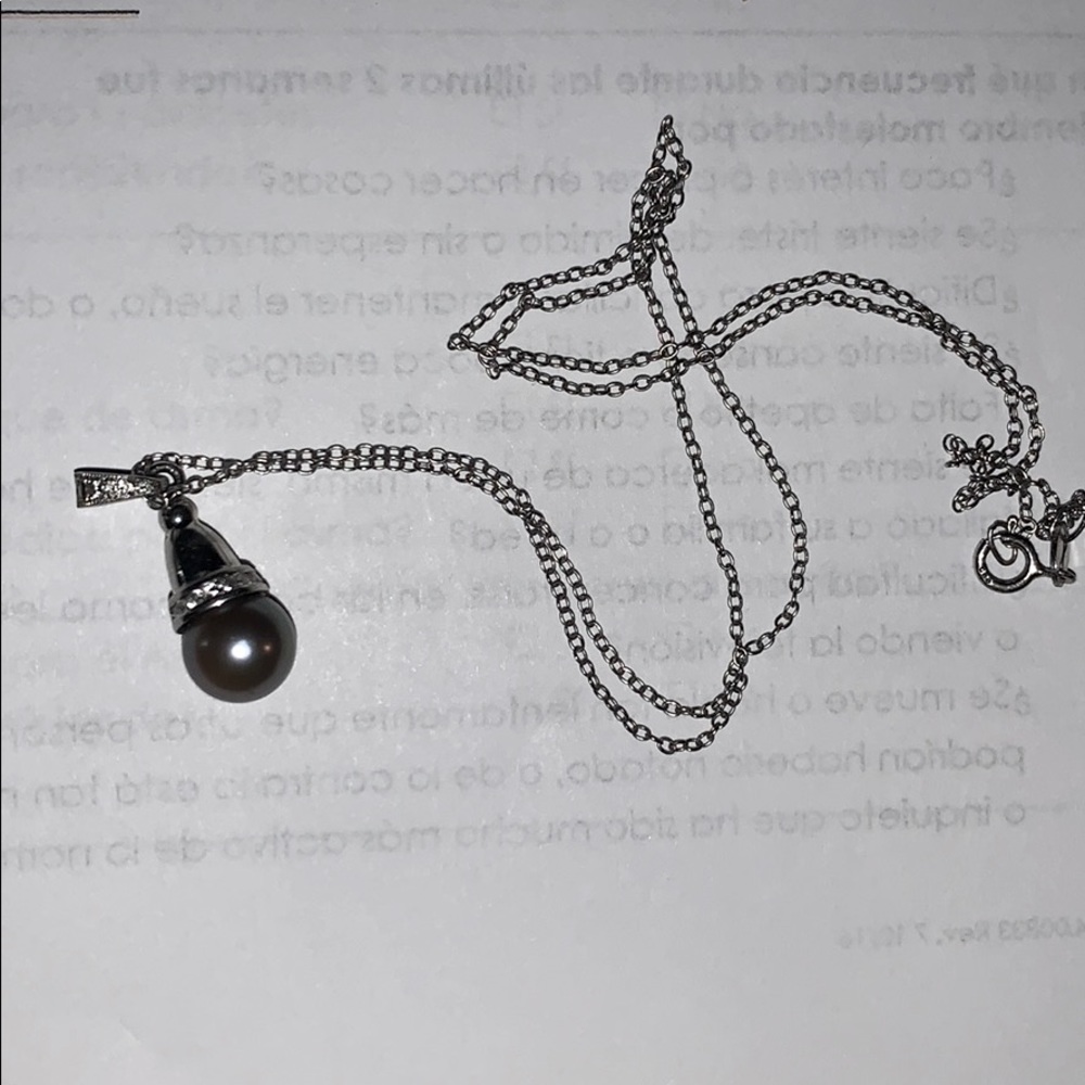 Black pearl with diamonds in platinum setting